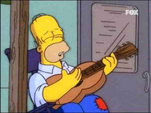 Homer Simpson, amb una guitarra. Font: youtube.com